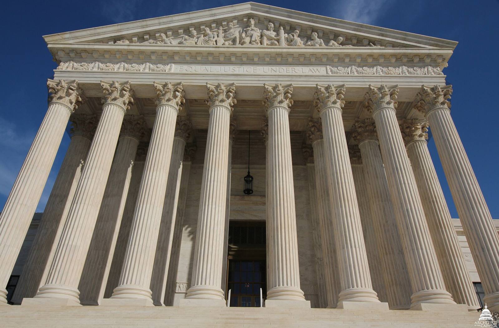 West front of the United States Supreme Court building, with marble columns, sculpted pediment, and steps, after the facade restoration